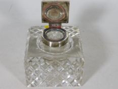 A silver topped cut glass inkwell
