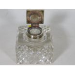 A silver topped cut glass inkwell