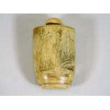 A Oriental bone snuff bottle with etched decor 2.7
