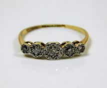 An 18ct gold ring with five diamonds set in platin