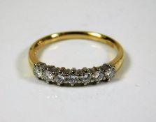 An 18thC. gold ring set with seven diamonds, maker