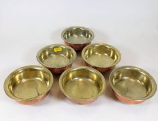 A set of six silver on copper Tibetan bowls