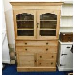 A 19thC. pine kitchen dresser with glazed cupboard