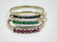 A 14ct gold trilogy set of sapphire, emerald & rub