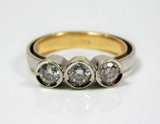 An 18ct two tone gold trilogy ring set with approx. 0.9ct of diamond 5.7g size M
