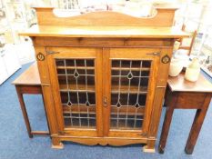 A Shapland and Petter style arts & crafts oak bookcase with coloured glass inserts. Provenanc