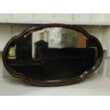 A decorative framed wall mirror