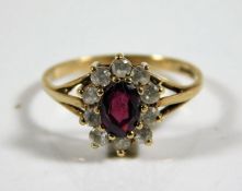 A 9ct gold ring set with garnet & white stones 1.5