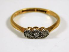 An 18ct gold ring with three platinum mounted diam