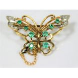 A 9ct gold butterfly brooch set with diamond & eme