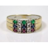 An 18ct gold ring set with three emeralds, sapphir