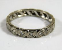 An antique 18ct white gold eternity ring set with