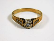 A 9ct gold ring set with small centre stone & ston