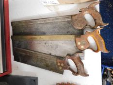 Three hand saws, one with brass top