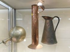 A hammered copper jug & two other stylised metal v