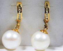 A pair of South Sea 12mm pearl earrings mounted with 14ct gold & set with diamonds 10.6g