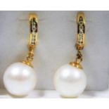 A pair of South Sea 12mm pearl earrings mounted with 14ct gold & set with diamonds 10.6g