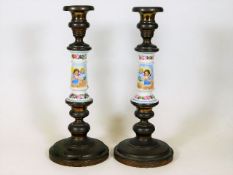 A pair of plated candlesticks with Sevres style po
