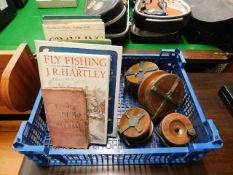 Four fly fishing reels twinned with fly fishing bo