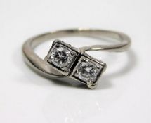 A white metal diamond crossover ring set with appr