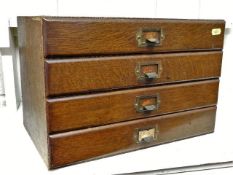 A small set of oak stationery drawers