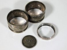 Two silver napkin rings, a small silver scarf ring