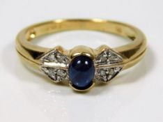 A 9ct gold ring set with cabochon sapphire & diamo