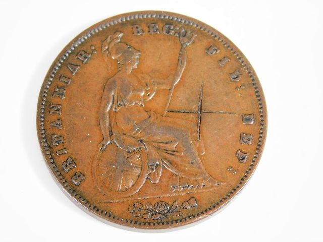 An 1858 British copper penny no WW with scratch ma