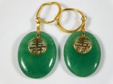 A pair of Chinese jade earrings mounted with fine