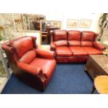 An antique style red leather two piece suite