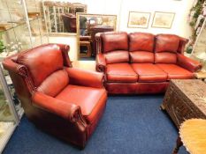 An antique style red leather two piece suite