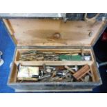 A carpentry box of mixed tools including planes