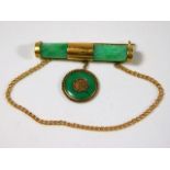 A Chinese jade brooch mounted with 20ct gold 9.3g