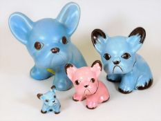 A collection of four Sylvac style dog puppies