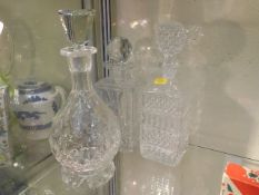 A cut glass decanter & two others