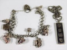 A silver charm bracelet twinned with a silver ingo