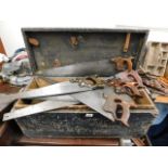 A carpentry box with various hand saws including D