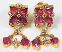 A pair of 18ct gold drop earrings set with Burmese