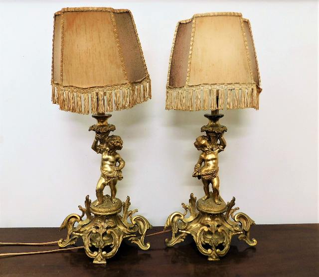 A pair of French gilt bronze bedside lamps with pu