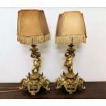 A pair of French gilt bronze bedside lamps with pu