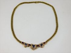 A heavy gauge 18ct gold necklace set with three he