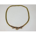 A heavy gauge 18ct gold necklace set with three he