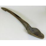A 19thC. carved gruel spoon, 24in