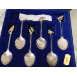 A set of six silver plated spoons with bird finial
