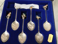 A set of six silver plated spoons with bird finial