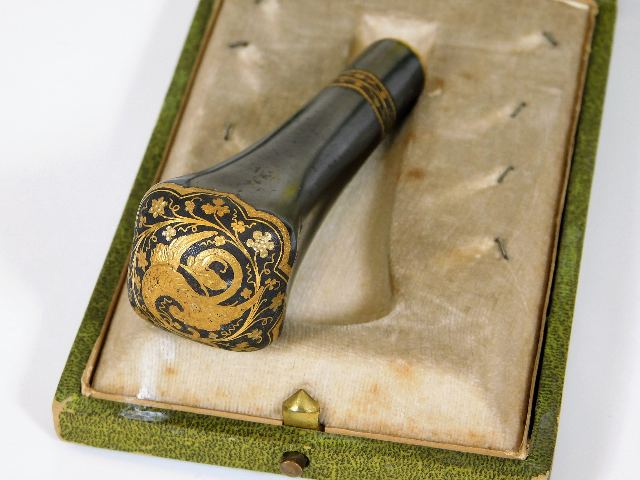 A boxed Toledo steel cane handle with gold inlay