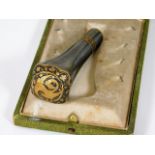 A boxed Toledo steel cane handle with gold inlay