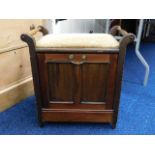 An antique music stool with pull down front music