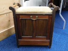 An antique music stool with pull down front music