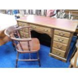 A vintage desk with mahogany veneer twinned with a